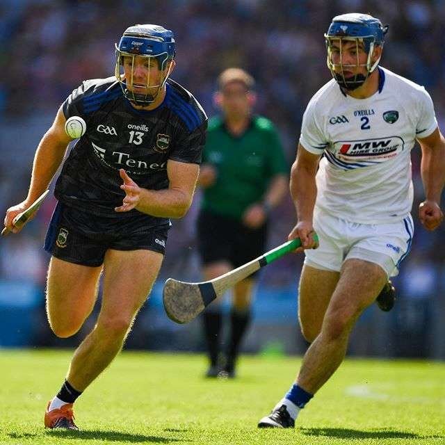 Two hurlers chase a Conroy sliotar in a championship match